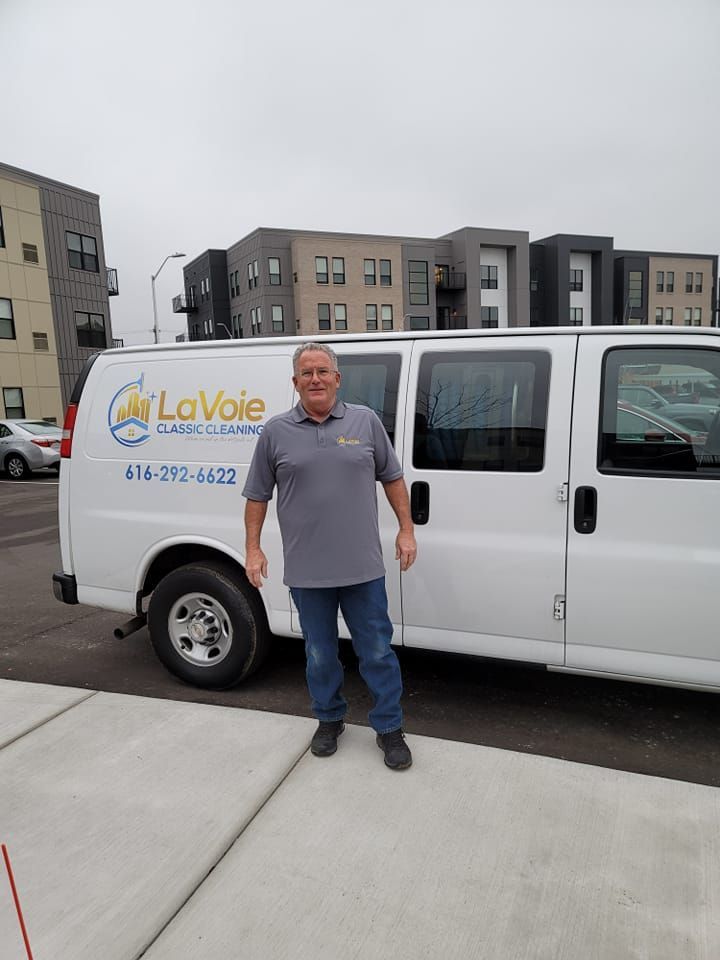 A man is standing in front of a white van.