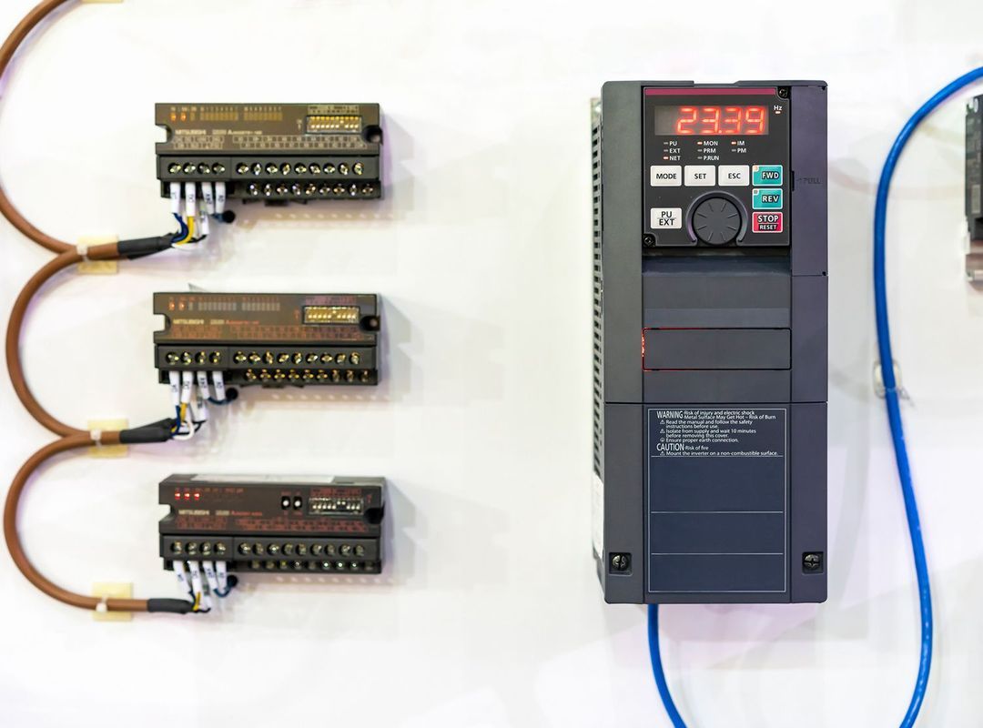 A close up of a inverter with a bunch of wires attached to it.