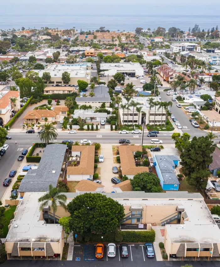 An aerial view of a city with lots of buildings and cars