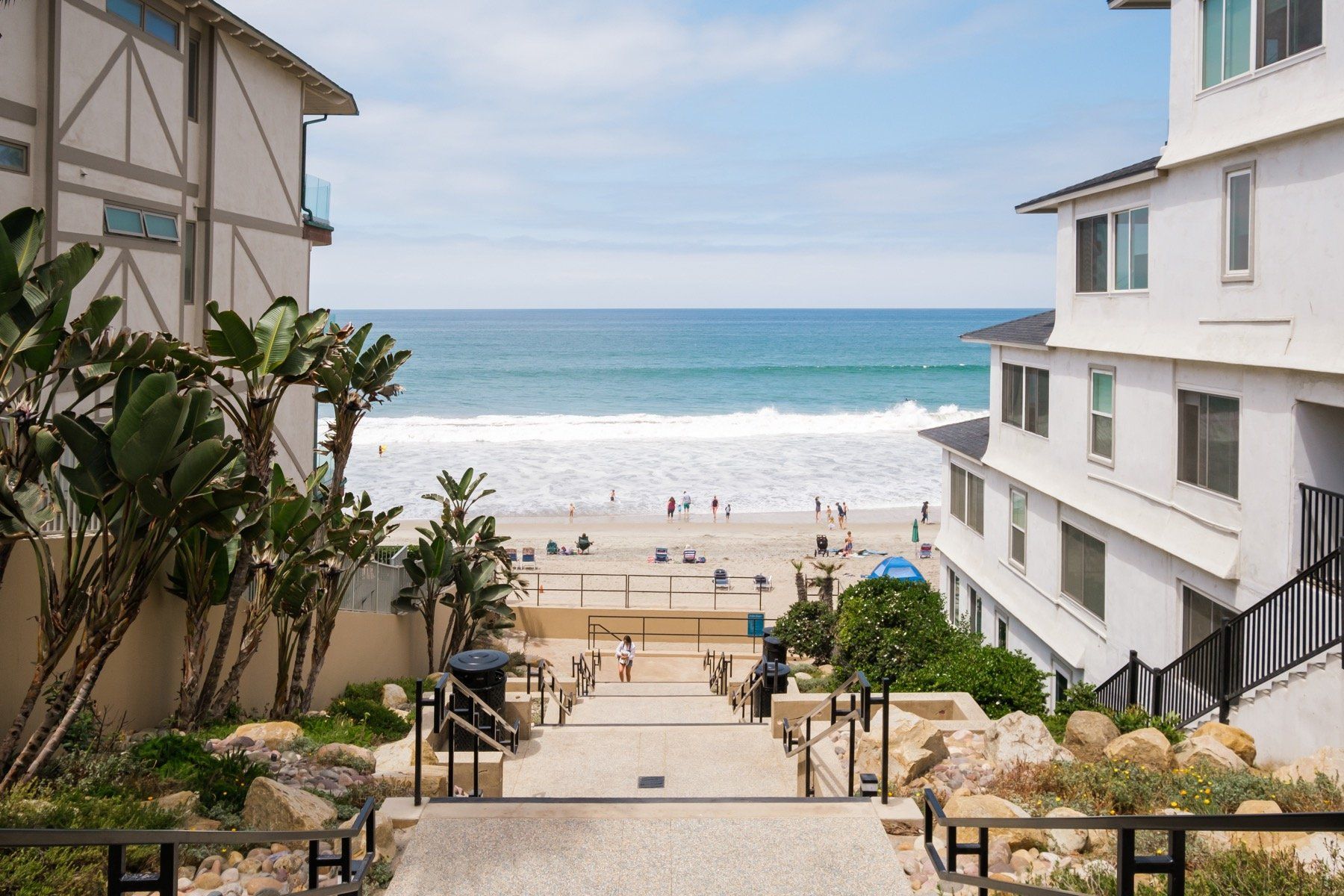 Stairs leading up to a beach with a view of the ocean