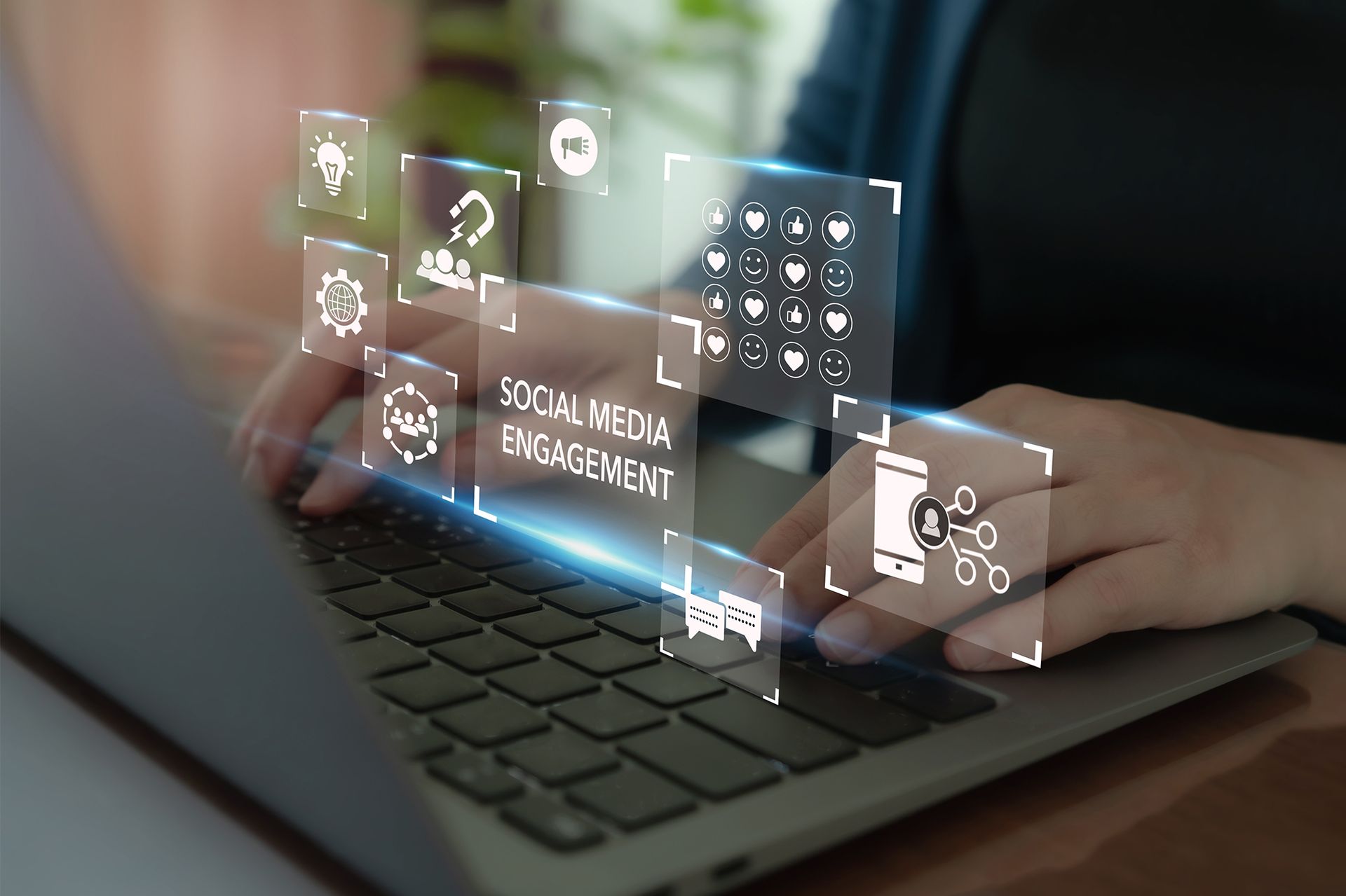 A person is typing on a laptop computer with a futuristic screen.