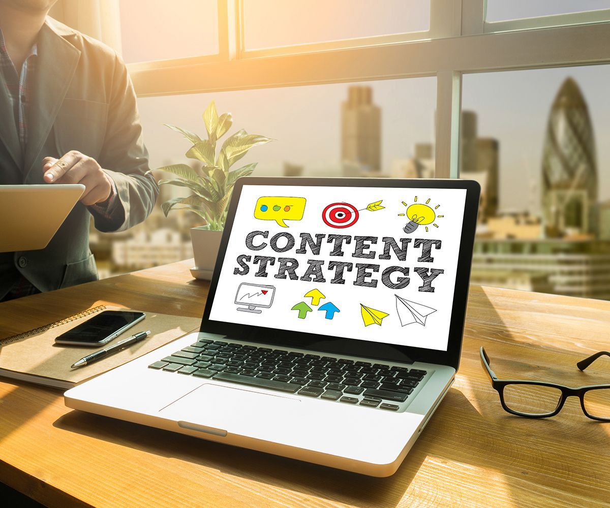 A laptop computer is open to a screen that says content strategy.