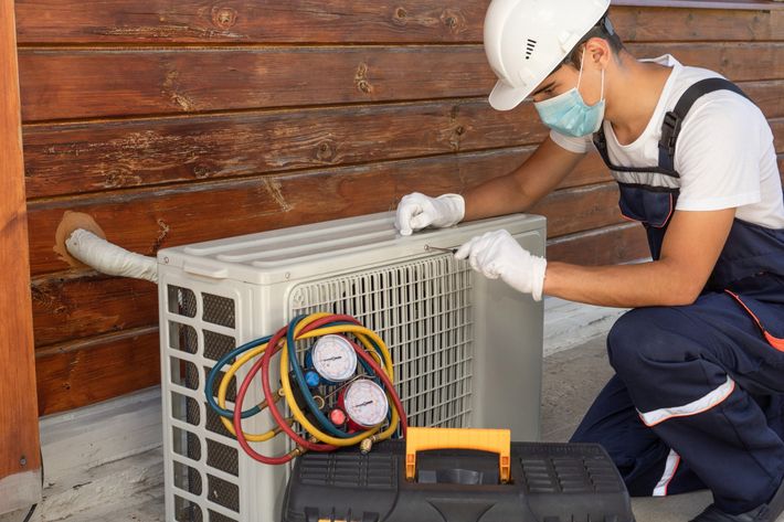 Contractor Repairing Air Conditioner — Buhler, KS — Reimer Refrigeration