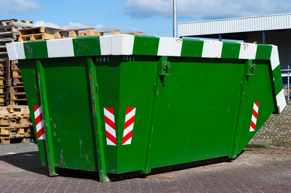 A Green Dumpster with Red and White Stripes on It — Northern Rivers Demolition & Asbestos in Casino, NSW
