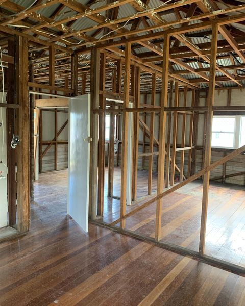 An Empty Room with Wooden Beams and A Wooden Floor — Northern Rivers Demolition & Asbestos in Byron Bay, NSW