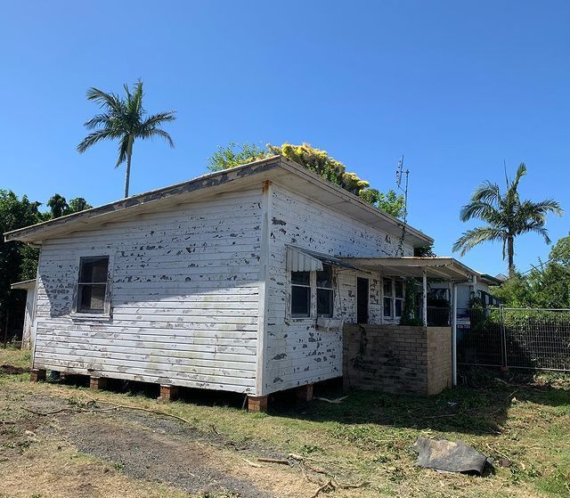 A Small White House with Palm Trees in The Background — Northern Rivers Demolition & Asbestos in Skennars Head, NSW
