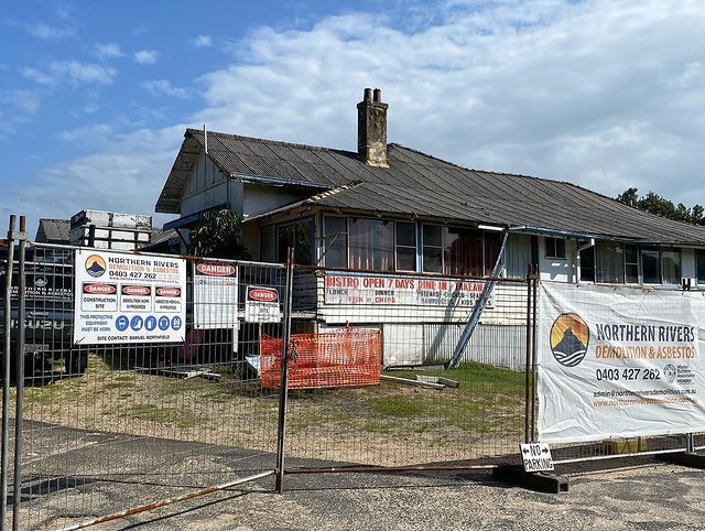 A House Is Behind a Fence with A Sign on It — Northern Rivers Demolition & Asbestos in Skennars Head, NSW