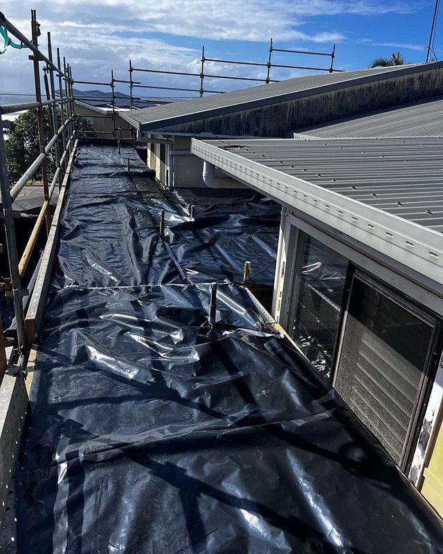 A Roof with Scaffolding and A Black Tarp on It — Northern Rivers Demolition & Asbestos in Lismore, NSW