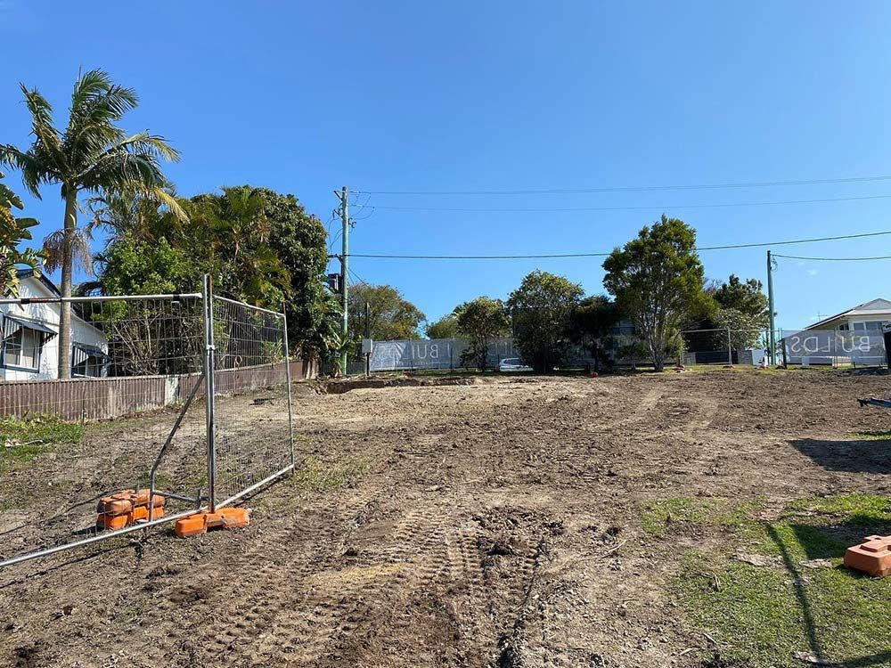 A Dirt Field with A Fence and Trees in The Background — Northern Rivers Demolition & Asbestos in Yamba, NSW