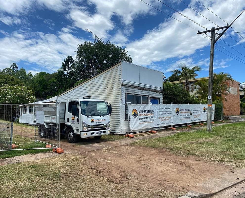 A White Truck Is Parked in Front of A Building Under Construction — Northern Rivers Demolition & Asbestos in Skennars Head, NSW