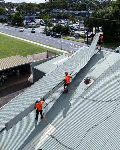 Two Men Are Working on The Roof of A Building — Northern Rivers Demolition & Asbestos in Ballina, NSW