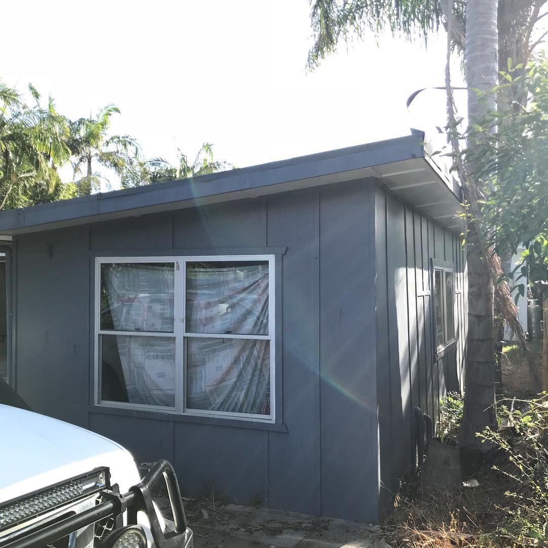 Grey Paint House With White Glass Window — Northern Rivers Demolition & Asbestos in Skennars Head, NSW