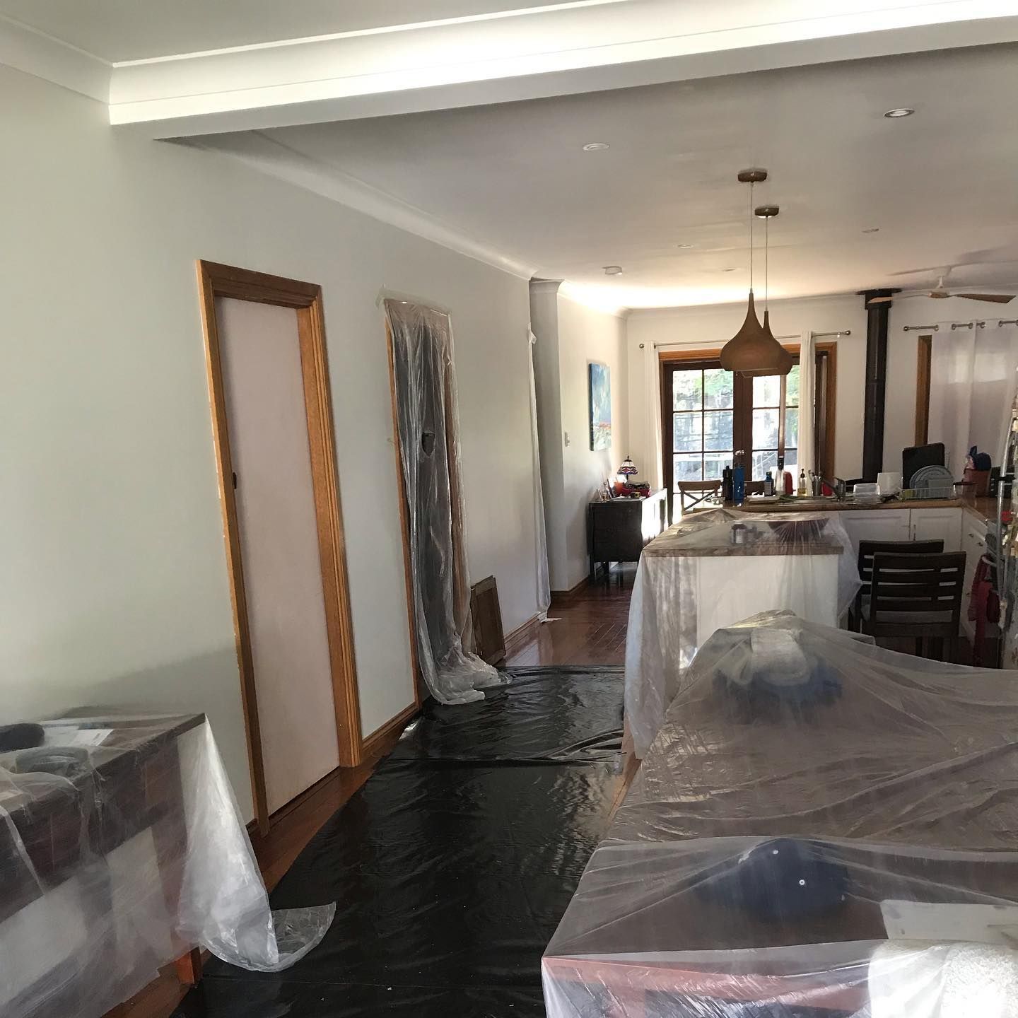 A Room with A Table and Chairs Covered in Plastic — Northern Rivers Demolition & Asbestos in Skennars Head, NSW
