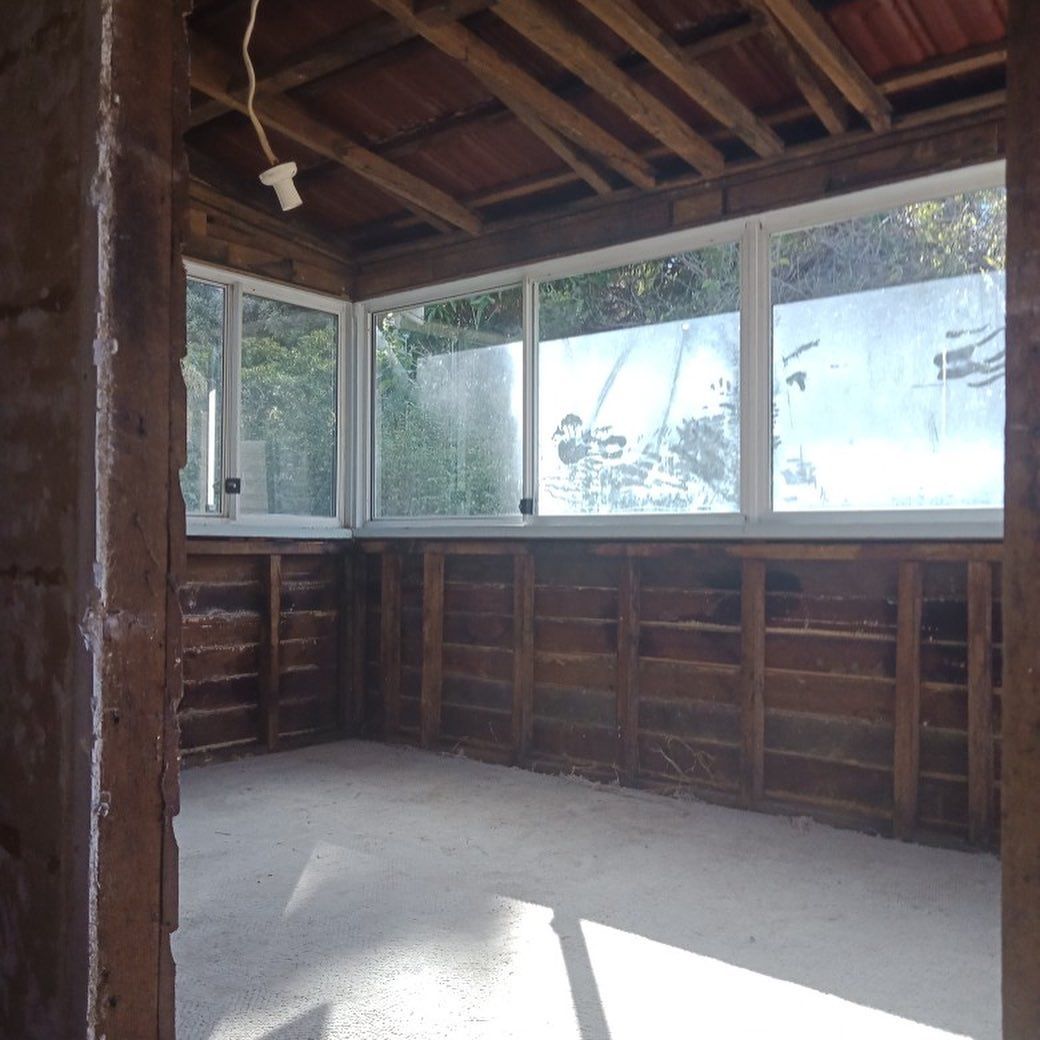 Wooden Wall With Sliding Windows And White Floor — Northern Rivers Demolition & Asbestos in Yamba, NSW