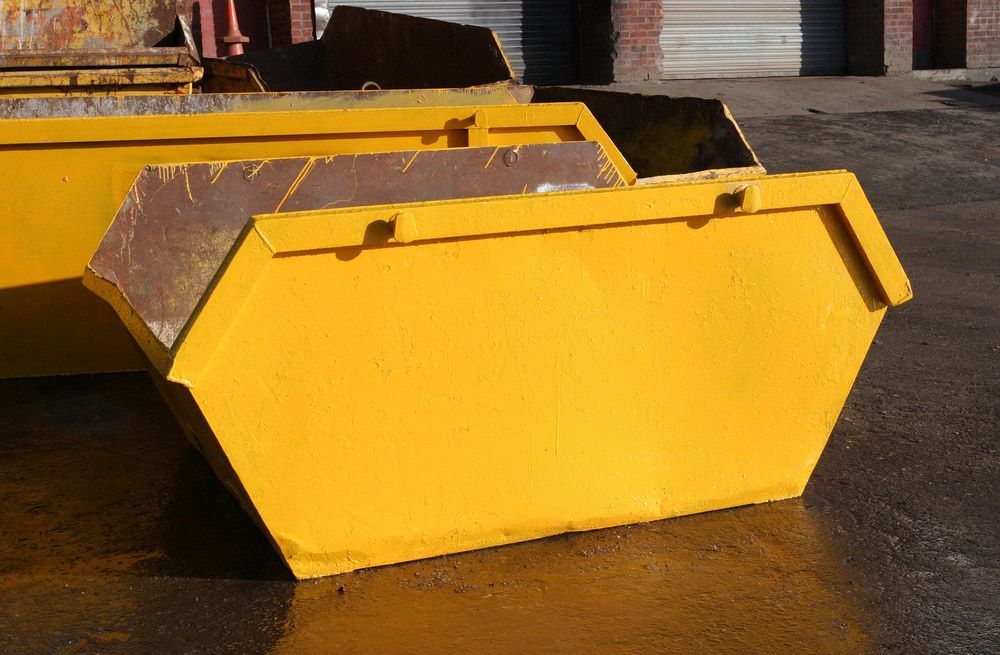 Two Yellow Dumpsters Are Stacked on Top of Each Other in A Parking Lot — Northern Rivers Demolition & Asbestos in Casino, NSW