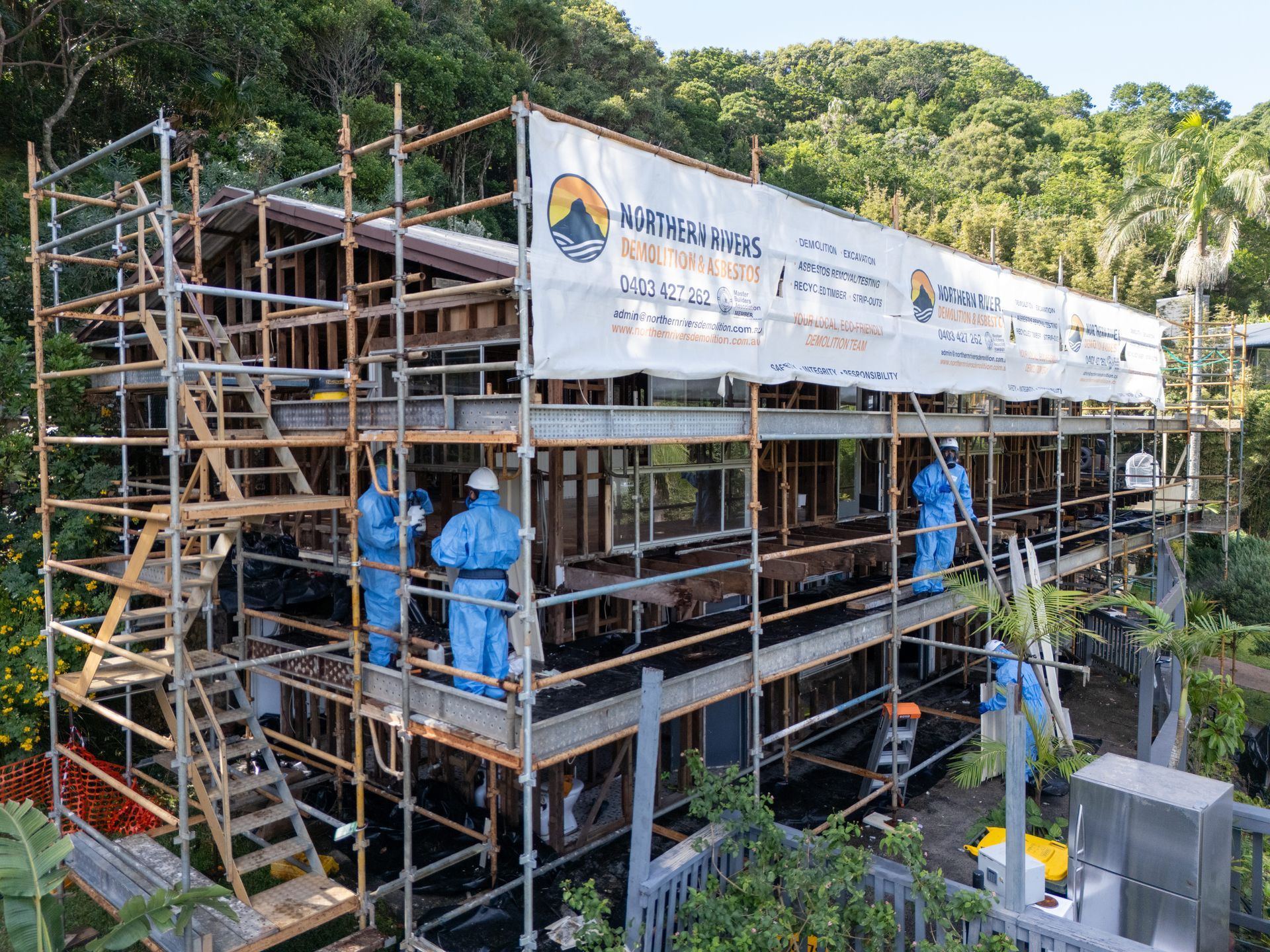 Men on Scaffolding Against House