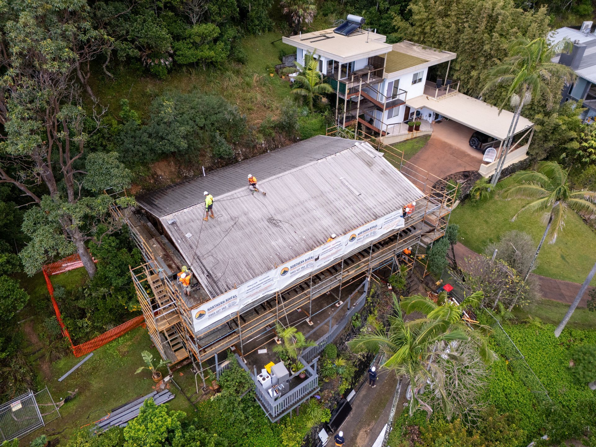 An aerial view of a house being built on top of a hill.