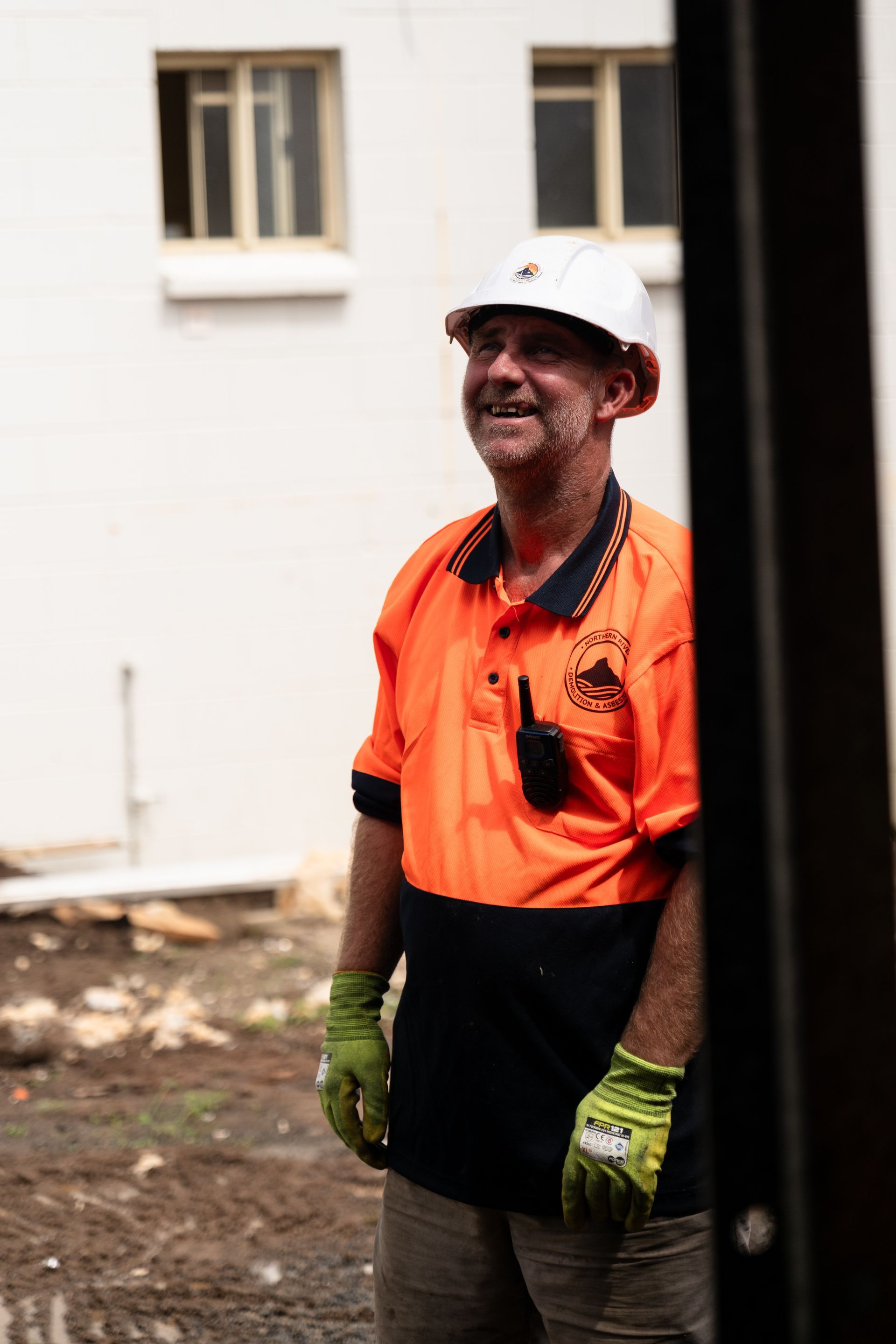 Worker Standing on Construction Site Smiling — Northern Rivers Demolition & Asbestos in Skennars Head, NSW