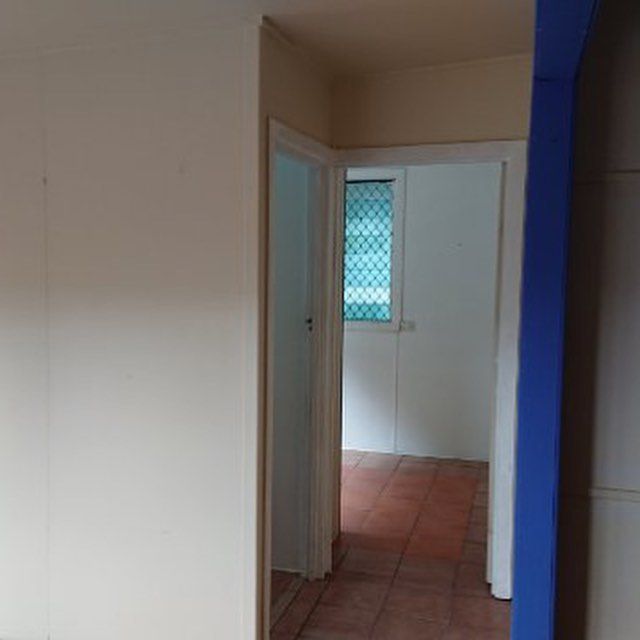 A Hallway with A Blue Pillar and A White Wall — Northern Rivers Demolition & Asbestos in Byron Bay, NSW