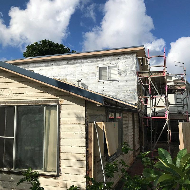 A White House with Scaffolding on The Side of It — Northern Rivers Demolition & Asbestos in Ballina, NSW