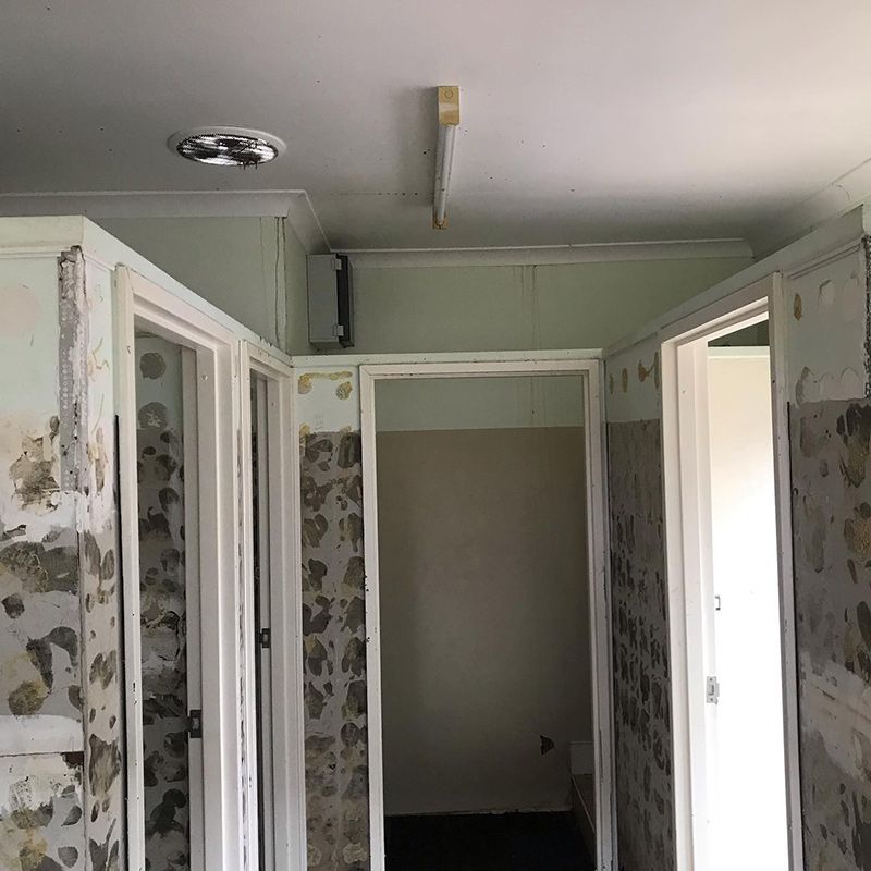 A Hallway with A Lot of Doors and A Ceiling Light — Northern Rivers Demolition & Asbestos in Casino, NSW