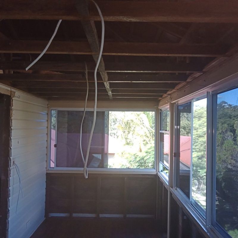 A Room with A Lot of Windows and Wires Hanging from The Ceiling — Northern Rivers Demolition & Asbestos in Lismore, NSW