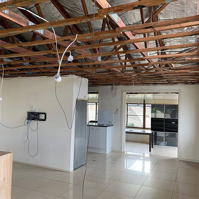 An Empty Room with A Wooden Ceiling and A Refrigerator — Northern Rivers Demolition & Asbestos in Lismore, NSW