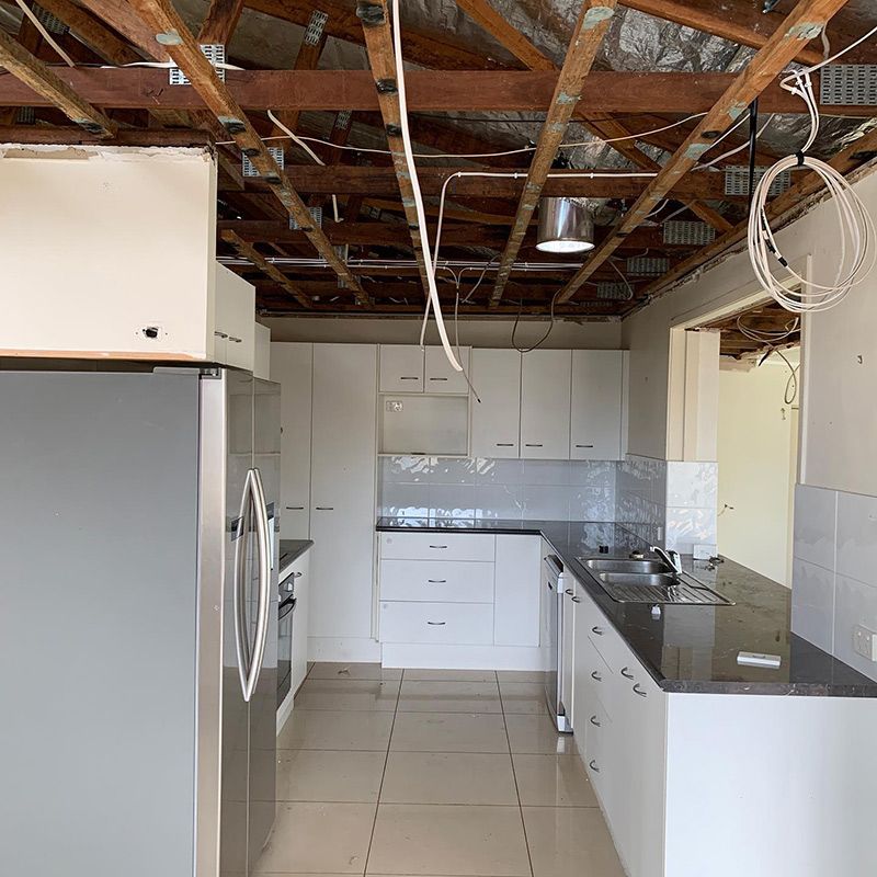 A Kitchen with White Cabinets and A Stainless Steel Refrigerator — Northern Rivers Demolition & Asbestos in Casino, NSW