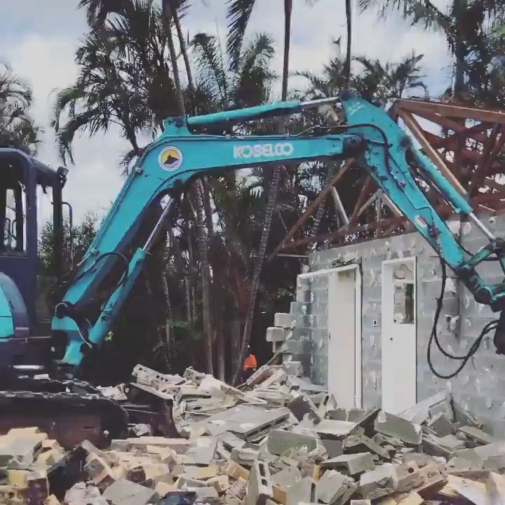 A Kobelco Excavator Is Demolishing a Building — Northern Rivers Demolition & Asbestos in Lismore, NSW