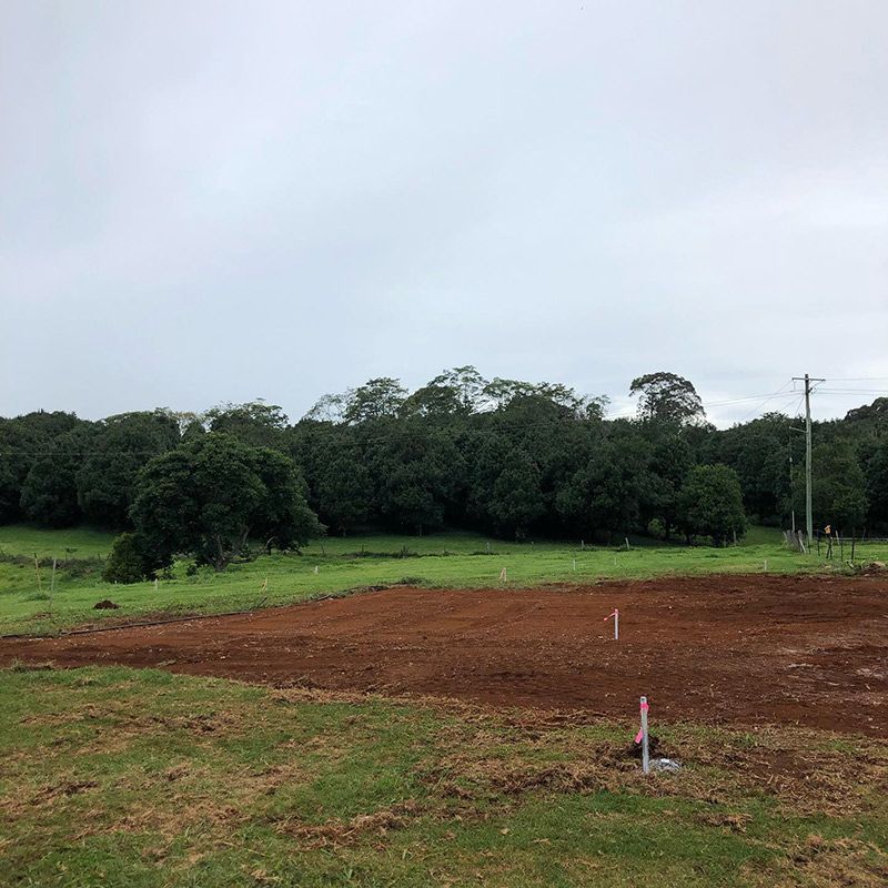 There Is a Lot of Dirt in The Middle of A Field with Trees in The Background — Northern Rivers Demolition & Asbestos in Grafton, NSW
