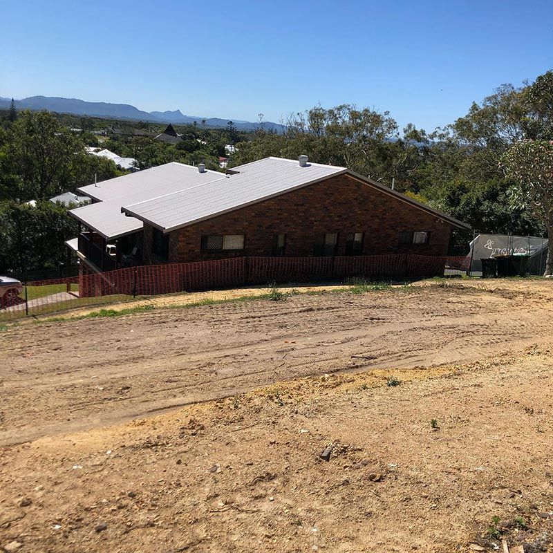 Perched on A Dirt Hill Is a Brick House — Northern Rivers Demolition & Asbestos in Byron Bay, NSW