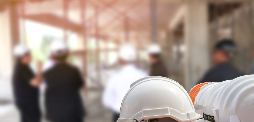 A Row of Hard Hats Sitting on Top of Each Other on A Construction Site — Northern Rivers Demolition 