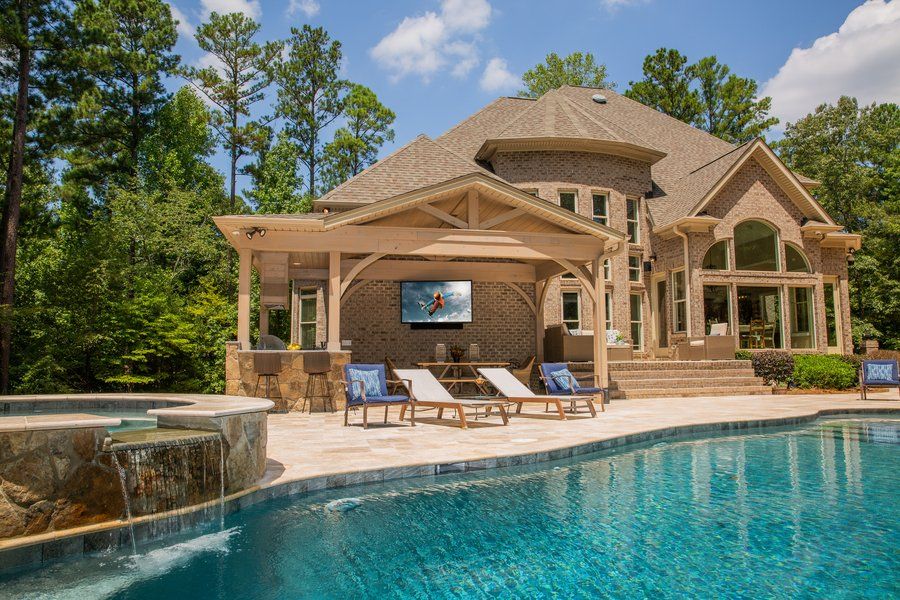 Backyard with swimming pool, lounge chairs, deck and outdoor TV