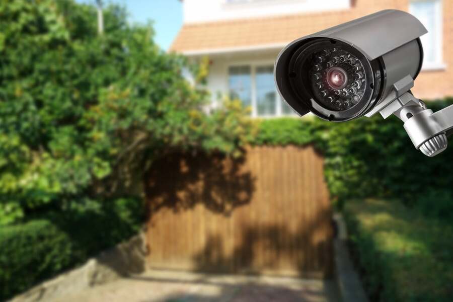 A surveillance camera oversees the outdoor spaces of a home.