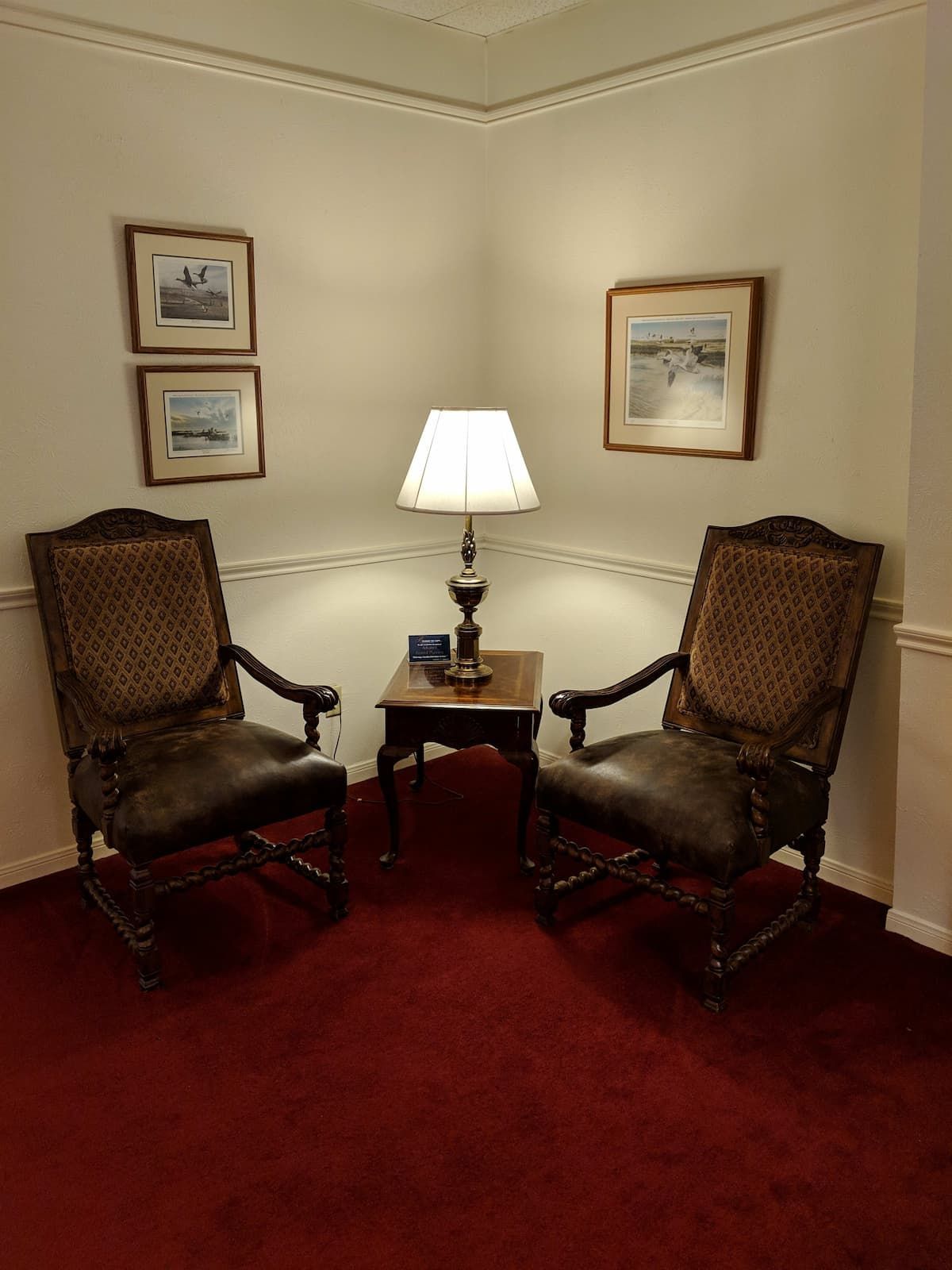 two rocking chairs are sitting next to each other in a corner of a room .