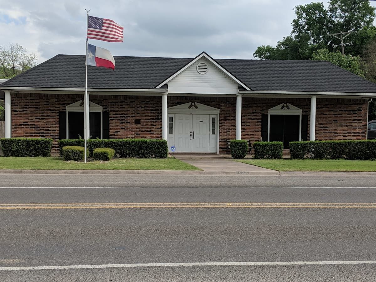 a brick building with a flag flying in front of it .