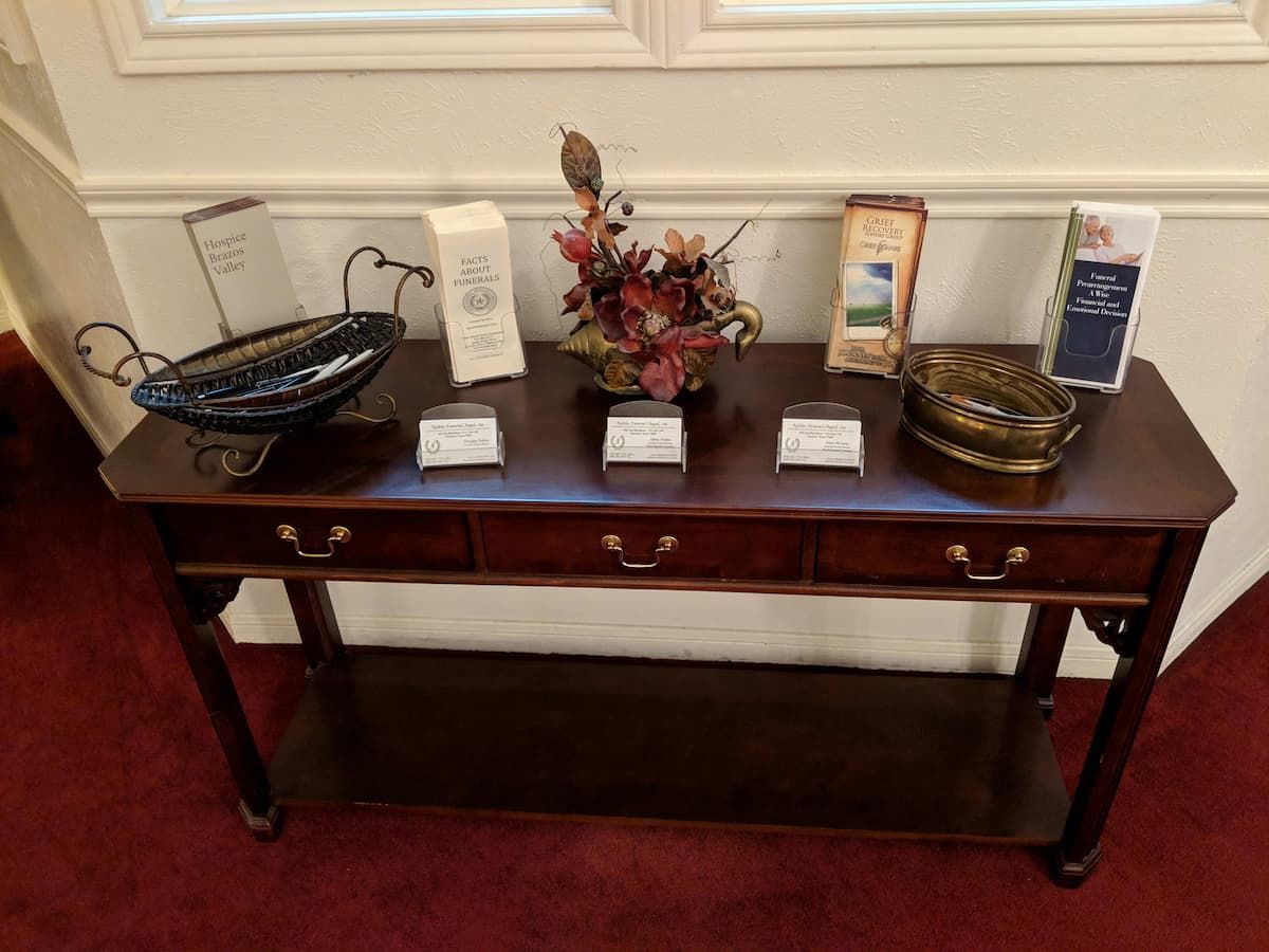 a wooden table with a vase of flowers on it