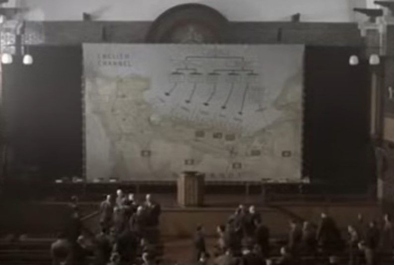 A man is standing in front of a model of a city