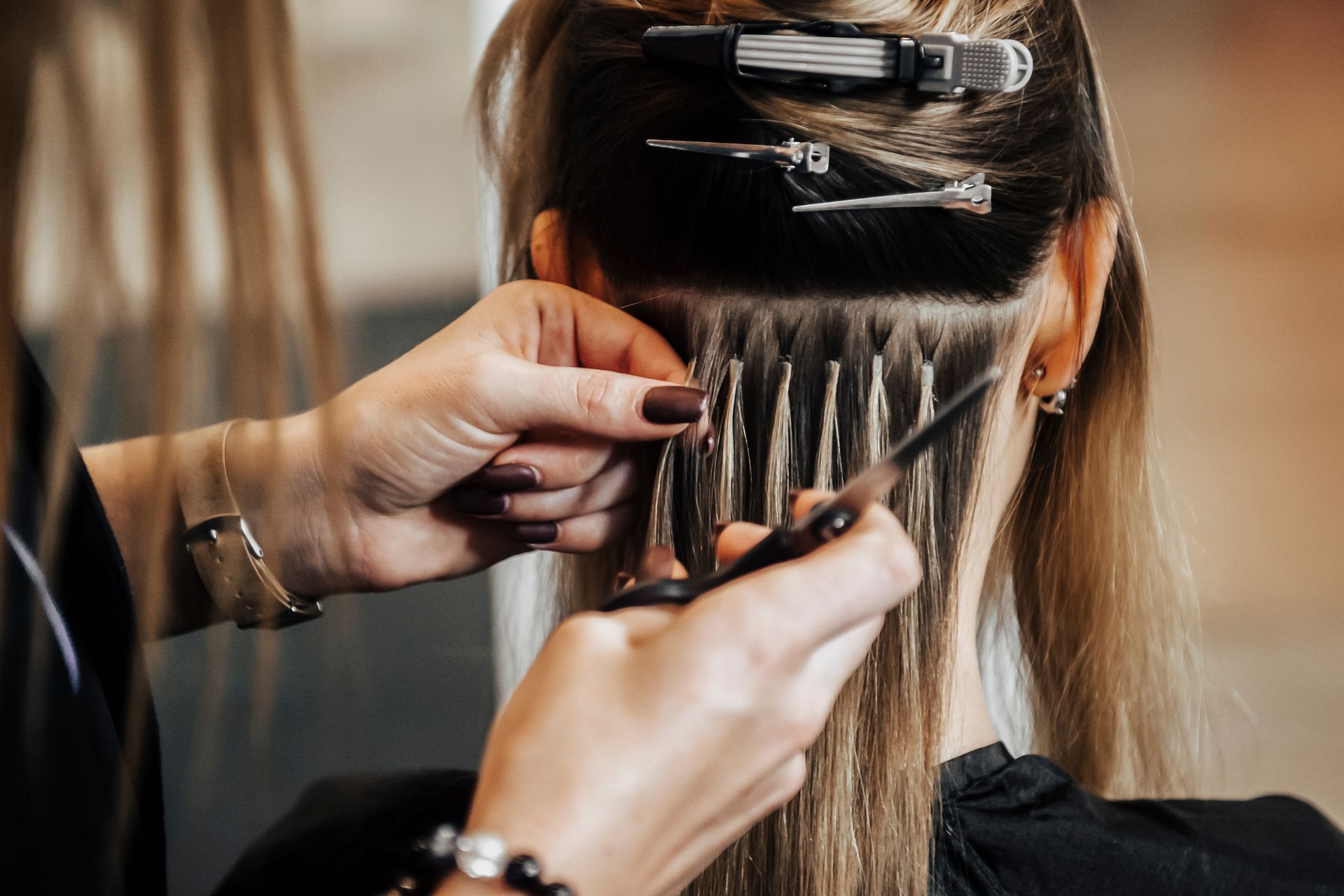 A woman is getting her hair done by a hairdresser.