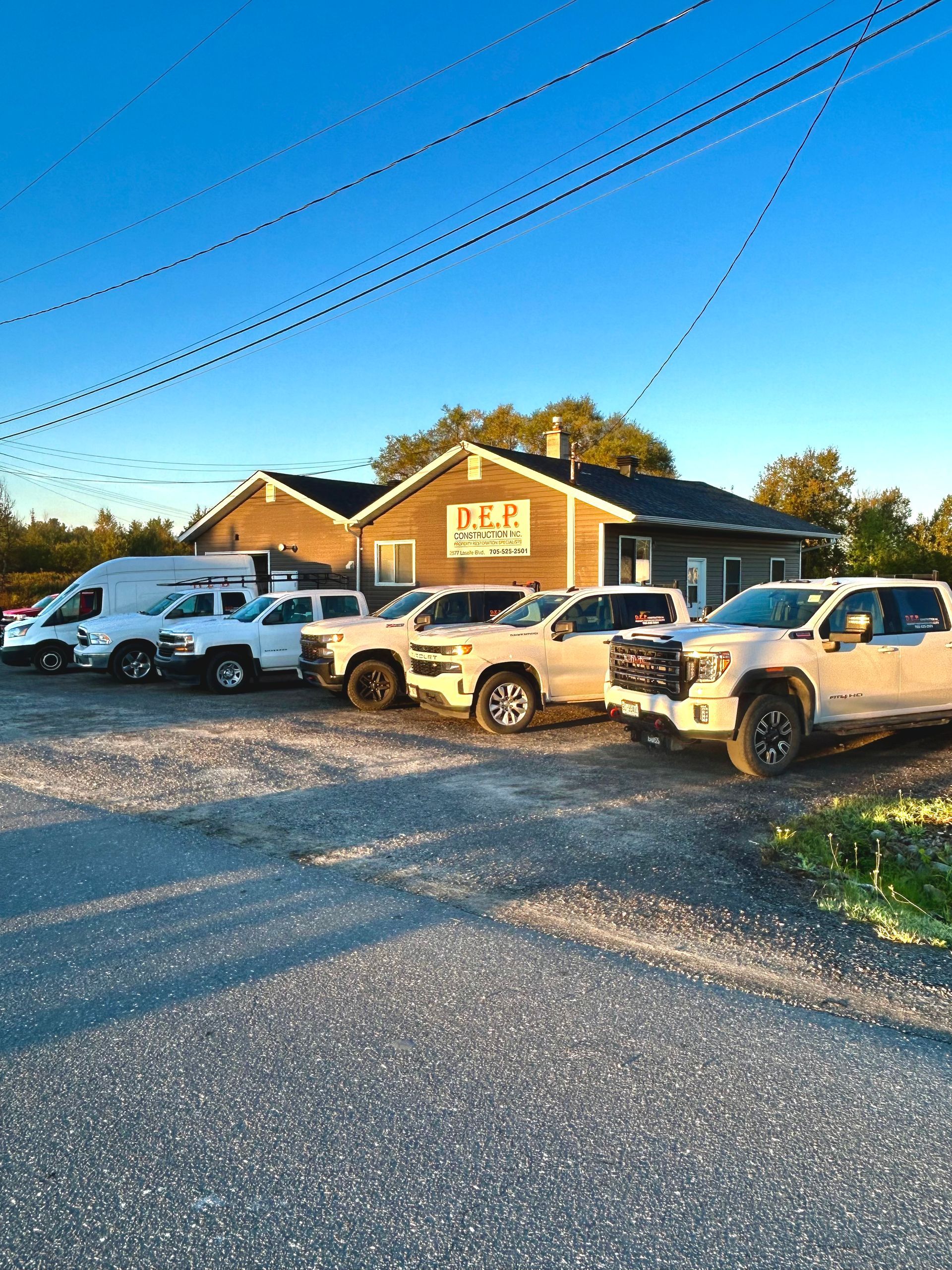 DEP Construction work trucks in front of office