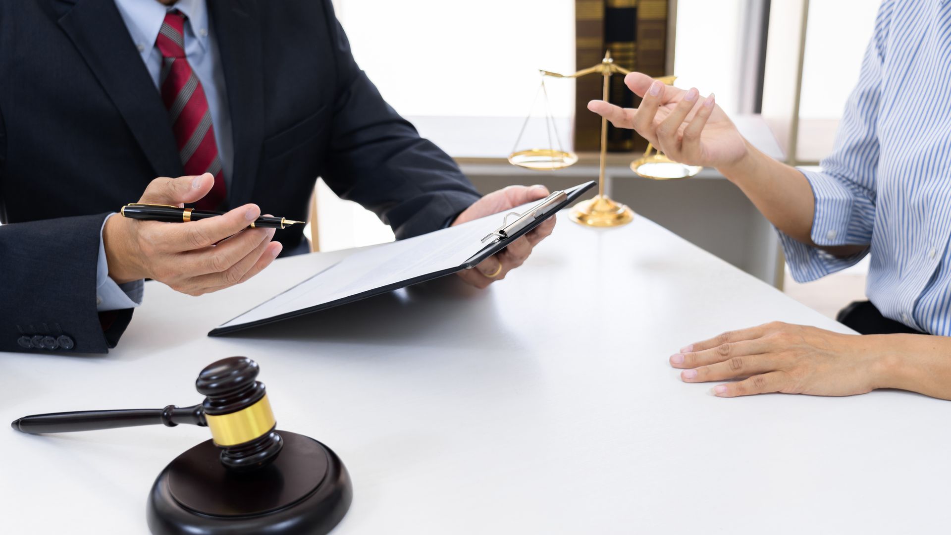 A lawyer working at his office while talking with a client. A lawyer working at his office while talking with a client.