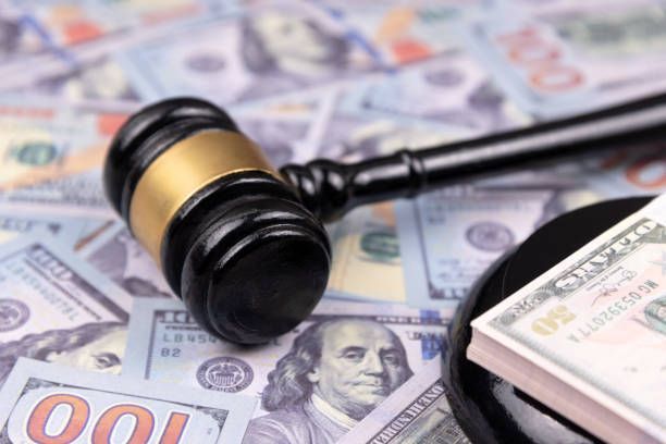 Gavel on top of hundred-dollar bills, symbolizing bail bond services.