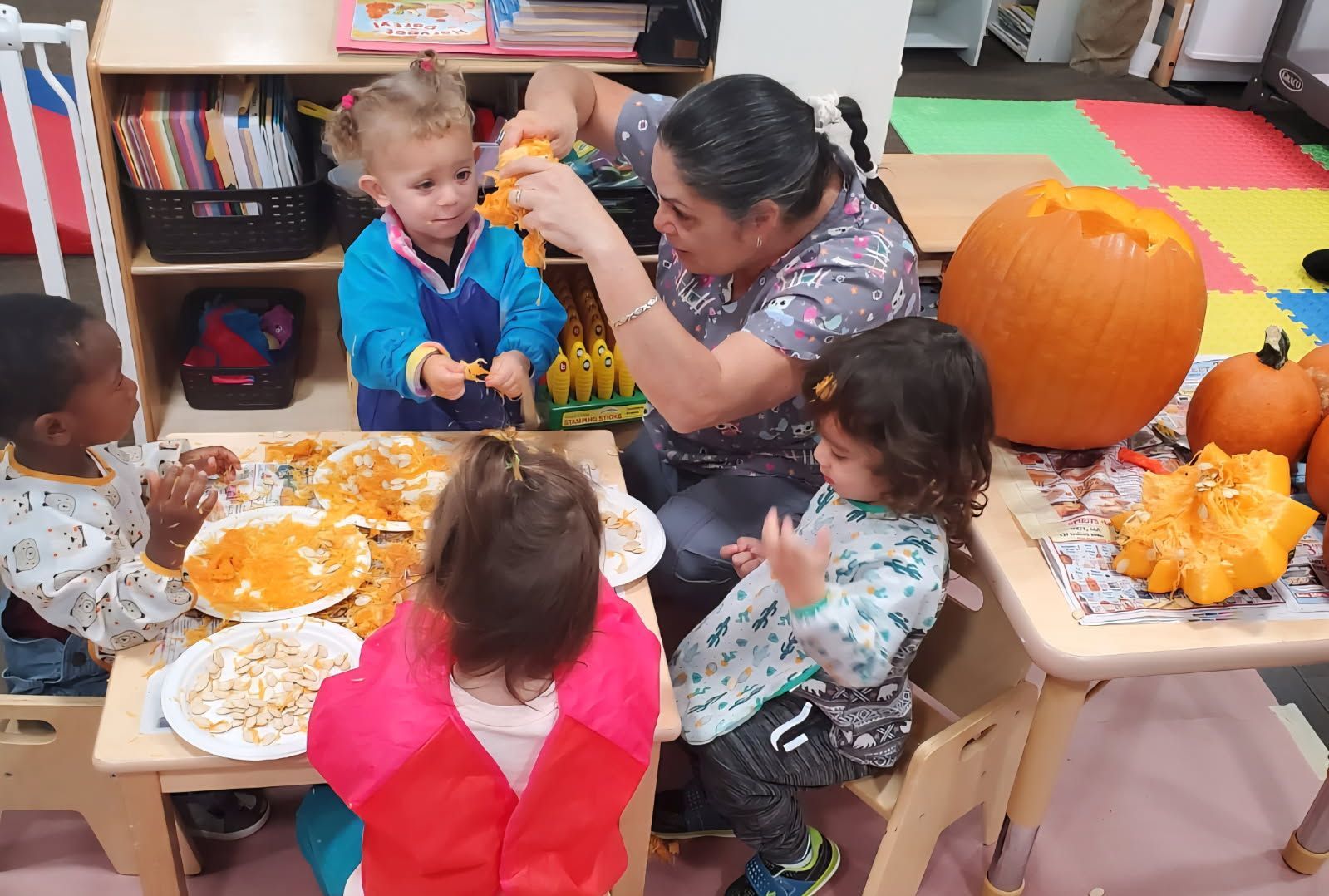 Children's story time in a library: Adults read to a circle of young children.