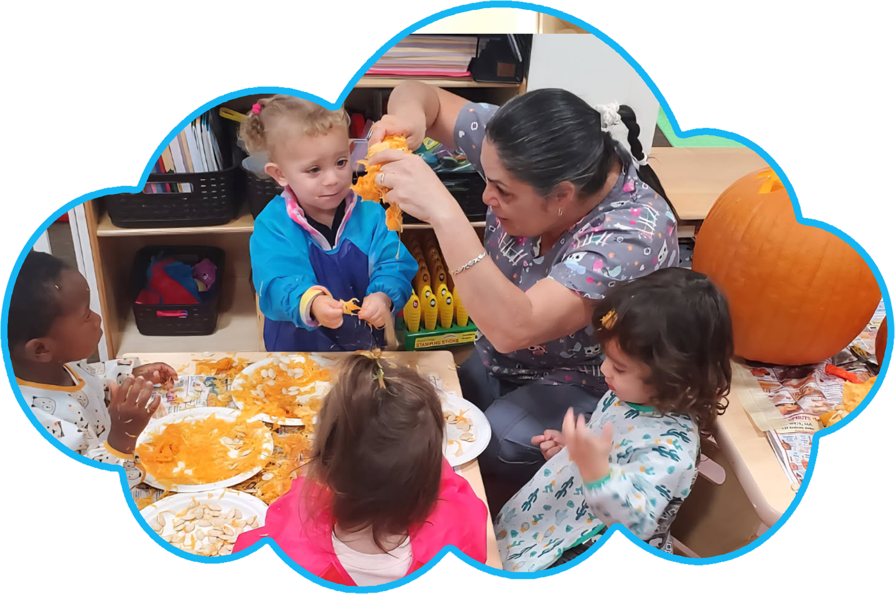Child playing with toys on the floor in a playroom. Shelves with toys are in the background.