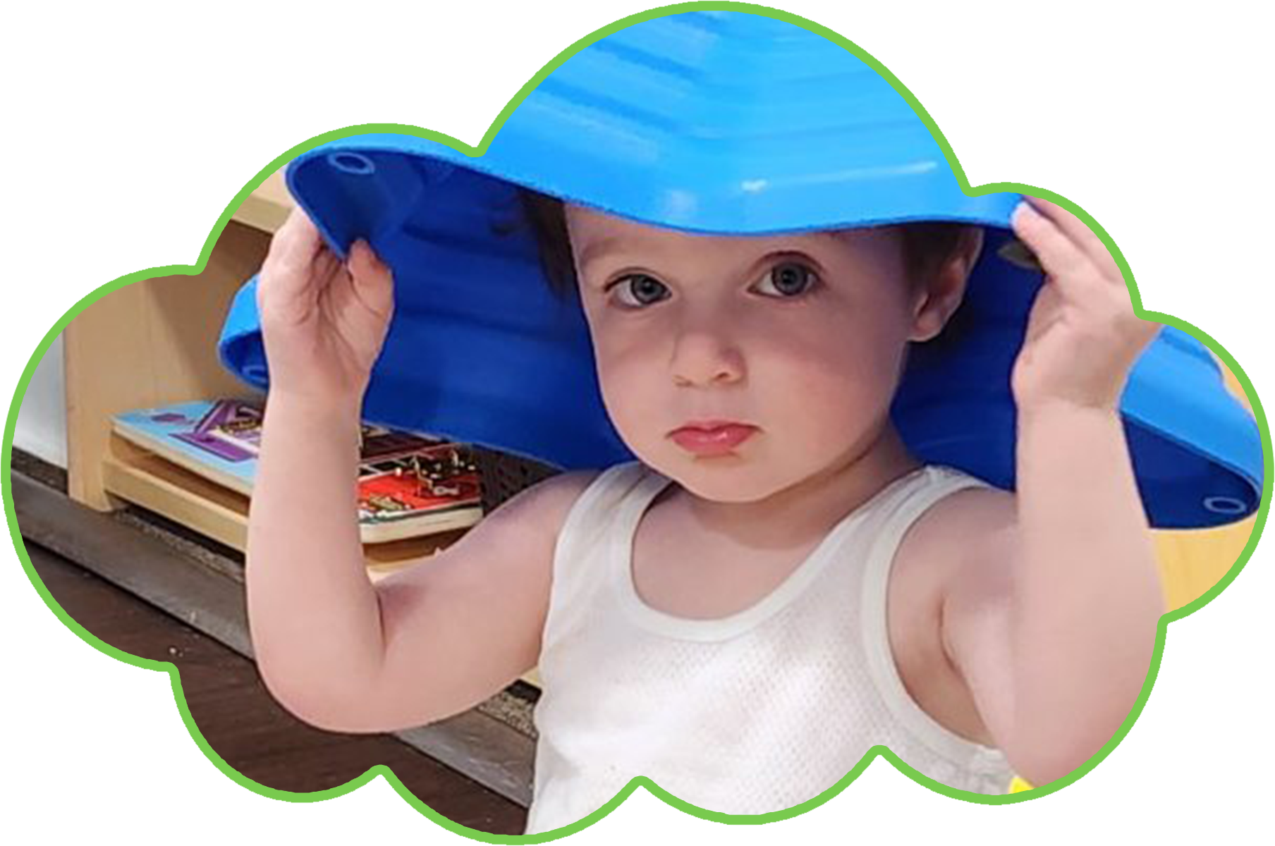 Two girls playing on playground equipment: one hanging from rings, the other watching.