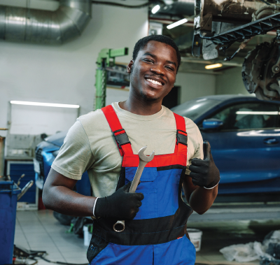 A family is sitting on a couch holding a drawing of their family.