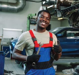 A family is sitting on a couch holding a drawing of their family.