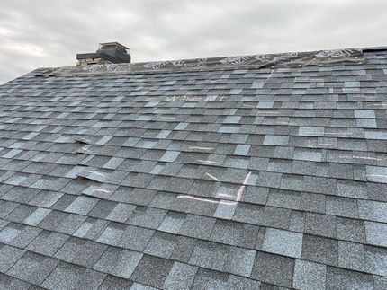 A close up of a roof with a chimney on top of it.