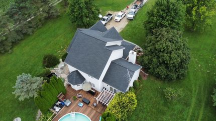 An aerial view of a house with a pool in the backyard.