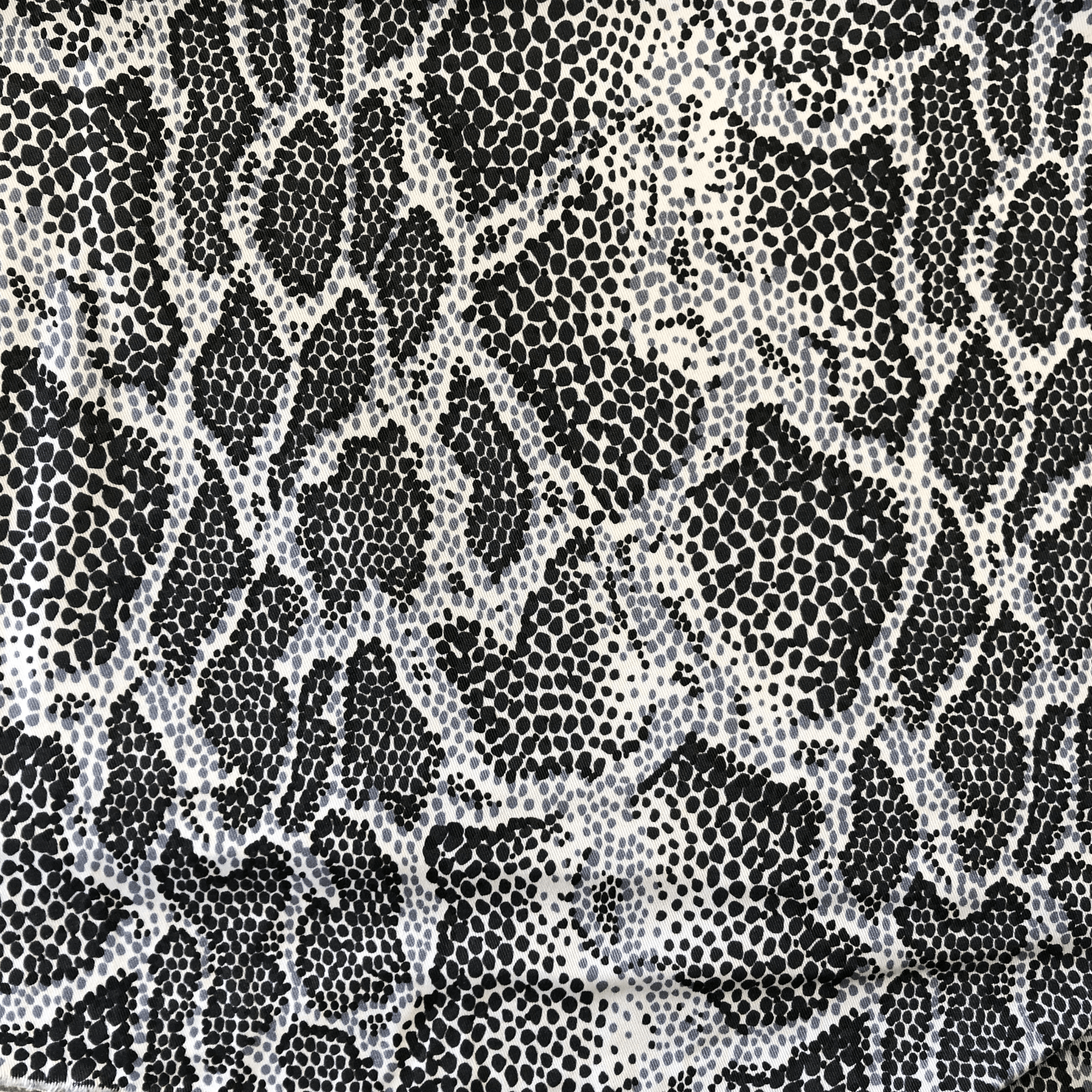 Tissu à motif peau de serpent noir et blanc.